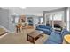 Inviting living room with plush blue sofas, a wooden coffee table, and a view of the open kitchen and dining area at 221 Hampton Station Blvd, Canton, GA 30115