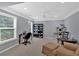 Home office with a desk, shelving, chair, sitting chair, and a large window overlooking the yard at 221 Hampton Station Blvd, Canton, GA 30115