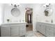 Bathroom offers a double vanity with framed mirrors and shiplap walls at 2410 Bankstone Sw Dr, Marietta, GA 30064