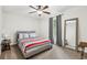 Bedroom with comfortable bed, bedside table and lamp, and a large mirror at 2410 Bankstone Sw Dr, Marietta, GA 30064