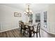 Bright dining room featuring wainscoting, dark wood table and chandelier at 2410 Bankstone Sw Dr, Marietta, GA 30064
