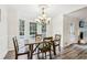 Bright dining room with a chandelier and windows offering a view of the pool at 2410 Bankstone Sw Dr, Marietta, GA 30064