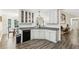 Bright kitchen features white cabinetry, gray counters, and wood-look floors at 2410 Bankstone Sw Dr, Marietta, GA 30064