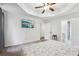 Open main bedroom with carpeting, tray ceiling, and television set for entertainment at 2410 Bankstone Sw Dr, Marietta, GA 30064
