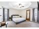 Spacious main bedroom features a tray ceiling, neutral color palette, and carpeting at 2410 Bankstone Sw Dr, Marietta, GA 30064