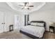 Large main bedroom with tray ceiling, carpeting, and access to the en-suite bathroom at 2410 Bankstone Sw Dr, Marietta, GA 30064