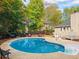 Backyard with sparkling blue swimming pool, patio, and lush landscaping offering an ideal outdoor space at 2410 Bankstone Sw Dr, Marietta, GA 30064
