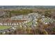 An aerial view of a well-planned residential community surrounded by lush trees and greenery in a tranquil setting at 3239 Bartee Walk, Suwanee, GA 30024