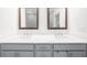 Modern bathroom featuring a dual sink vanity, light gray cabinets, and framed mirrors at 3239 Bartee Walk, Suwanee, GA 30024