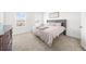Bright bedroom with neutral carpet, large windows, and a tufted headboard at 3239 Bartee Walk, Suwanee, GA 30024