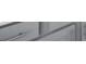 Close up of the gray shaker style cabinetry with stainless steel hardware at 3239 Bartee Walk, Suwanee, GA 30024