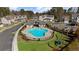 An aerial view of the community pool, set in a park-like location with playground, picnic tables and plenty of parking at 3239 Bartee Walk, Suwanee, GA 30024