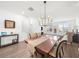 Bright dining room with wood floors, modern chandelier, and sliding glass doors to outdoor space at 3239 Bartee Walk, Suwanee, GA 30024