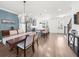 Open-concept dining area flows into a kitchen with stainless steel appliances and a breakfast bar at 3239 Bartee Walk, Suwanee, GA 30024