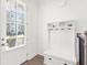 Bright entryway featuring a built-in coat rack and storage bench at 3239 Bartee Walk, Suwanee, GA 30024