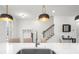 Stylish kitchen island featuring a modern faucet, pendant lighting, and bar seating at 3239 Bartee Walk, Suwanee, GA 30024
