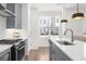 Well-equipped kitchen featuring modern appliances, white countertops, and sleek cabinetry at 3239 Bartee Walk, Suwanee, GA 30024