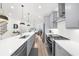 Contemporary kitchen featuring stainless appliances, white subway tile backsplash and an open view into the dining area at 3239 Bartee Walk, Suwanee, GA 30024