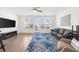 Spacious living room with hardwood floors, large windows, and comfortable seating at 3239 Bartee Walk, Suwanee, GA 30024