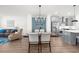 Open floor plan featuring a living room, dining room, and kitchen with modern finishes and stainless steel appliances at 3239 Bartee Walk, Suwanee, GA 30024