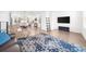 Open concept living room with hardwood floors, neutral decor, a large TV, and plenty of seating at 3239 Bartee Walk, Suwanee, GA 30024
