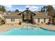 Community pool area with a spacious pool, lounge chairs, and a pavilion with outdoor fireplace and seating at 3239 Bartee Walk, Suwanee, GA 30024