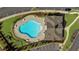 Aerial view of a community pool and pool house with plenty of open space and parking at 3239 Bartee Walk, Suwanee, GA 30024