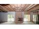 Unfinished basement with exposed wood ceiling and brick fireplace, offering great potential at 110 Vistacrest Way, Roswell, GA 30075