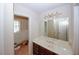 Bathroom featuring a vanity with double sinks and a view into an adjacent toilet and shower room at 110 Vistacrest Way, Roswell, GA 30075