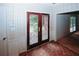 Entryway with patterned wallpaper, wood floors, and leaded glass front door at 110 Vistacrest Way, Roswell, GA 30075