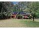 Charming brick home with manicured lawn and mature trees provides great curb appeal at 110 Vistacrest Way, Roswell, GA 30075