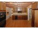 View of kitchen featuring wood cabinets, stainless steel sink and appliances, and wood flooring at 110 Vistacrest Way, Roswell, GA 30075