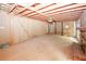 View of living room with brick fireplace, bare flooring and ceiling, and exposed framing at 110 Vistacrest Way, Roswell, GA 30075
