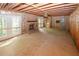 View of living room with brick fireplace, bare flooring and ceiling, and exposed framing at 110 Vistacrest Way, Roswell, GA 30075