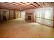 View of living room with brick fireplace, bare flooring and ceiling, and exposed framing at 110 Vistacrest Way, Roswell, GA 30075