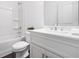 Bright bathroom with a shower-tub combo and a white vanity featuring modern fixtures and hardware at 244 Church St, Lawrenceville, GA 30046