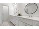 Well-lit bathroom with double sink vanity, marble countertops, and stylish round mirrors at 244 Church St, Lawrenceville, GA 30046