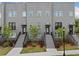 Modern townhome with brick facade, manicured landscaping, and inviting stairways to each unit's private entrance at 244 Church St, Lawrenceville, GA 30046