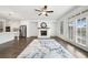 Bright, open-concept living area with hardwood floors, a fireplace, and seamless access to the kitchen and outdoor patio at 244 Church St, Lawrenceville, GA 30046