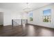 Bright and spacious loft area with hardwood floors, chandelier, and large windows overlooking the neighborhood at 244 Church St, Lawrenceville, GA 30046