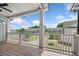 Covered porch with wooden decking and white railings, offering a serene outdoor living space with neighborhood views at 244 Church St, Lawrenceville, GA 30046