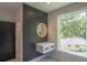 Stylish bathroom vanity with modern lighting and a view to backyard at 2740 Drew Valley Ne Rd, Brookhaven, GA 30319