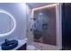 Modern bathroom featuring a vessel sink, sleek lighting, and a glass-enclosed shower with unique tile at 2740 Drew Valley Ne Rd, Brookhaven, GA 30319