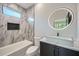 Modern bathroom features marble tile, a unique sink, and an illuminated round mirror at 2740 Drew Valley Ne Rd, Brookhaven, GA 30319