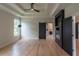 Bright bedroom with tray ceiling, modern ceiling fan, and black accent doors at 2740 Drew Valley Ne Rd, Brookhaven, GA 30319