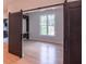 Bedroom with sliding barn doors and an accent window at 2740 Drew Valley Ne Rd, Brookhaven, GA 30319