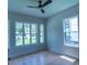 Bedroom with hardwood floors, ceiling fan and a multi-pane window at 2740 Drew Valley Ne Rd, Brookhaven, GA 30319