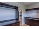 Custom closet with dark wood cabinets, granite counters, and closet rods for optimal storage and organization at 2740 Drew Valley Ne Rd, Brookhaven, GA 30319