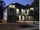 Exterior facade of a large 2 story home with stone and white wood accents at dusk at 2740 Drew Valley Ne Rd, Brookhaven, GA 30319
