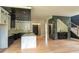 Large kitchen with a central island, custom cabinets, marble countertops, and modern fixtures adjacent to the staircase at 2740 Drew Valley Ne Rd, Brookhaven, GA 30319